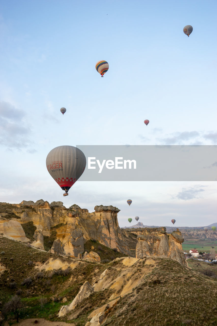 HOT AIR BALLOON FLYING OVER ROCKS