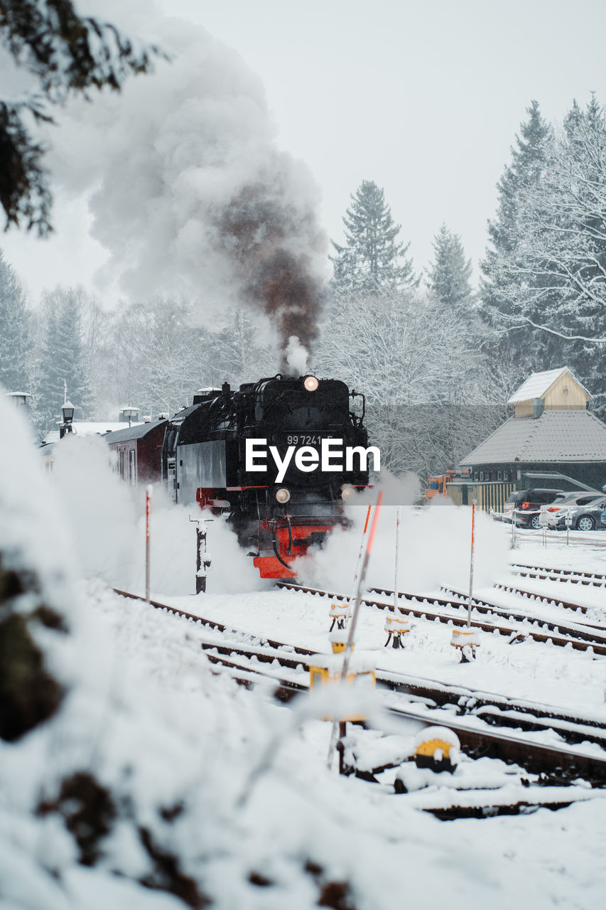 HIGH ANGLE VIEW OF TRAIN ON RAILROAD TRACK DURING WINTER