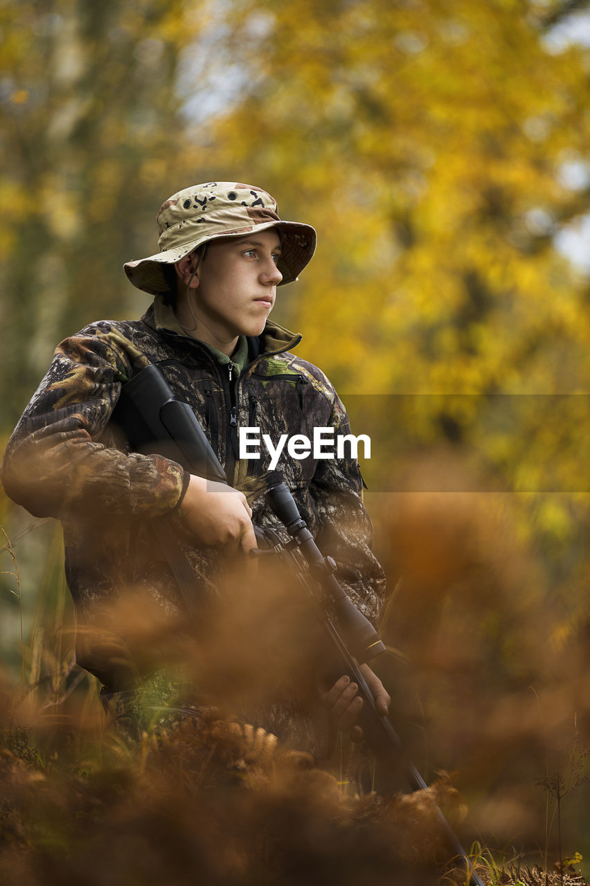 Teenage boy with rifle at hunting