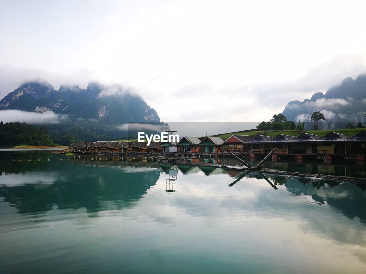 Scenic view of lake by mountains against sky