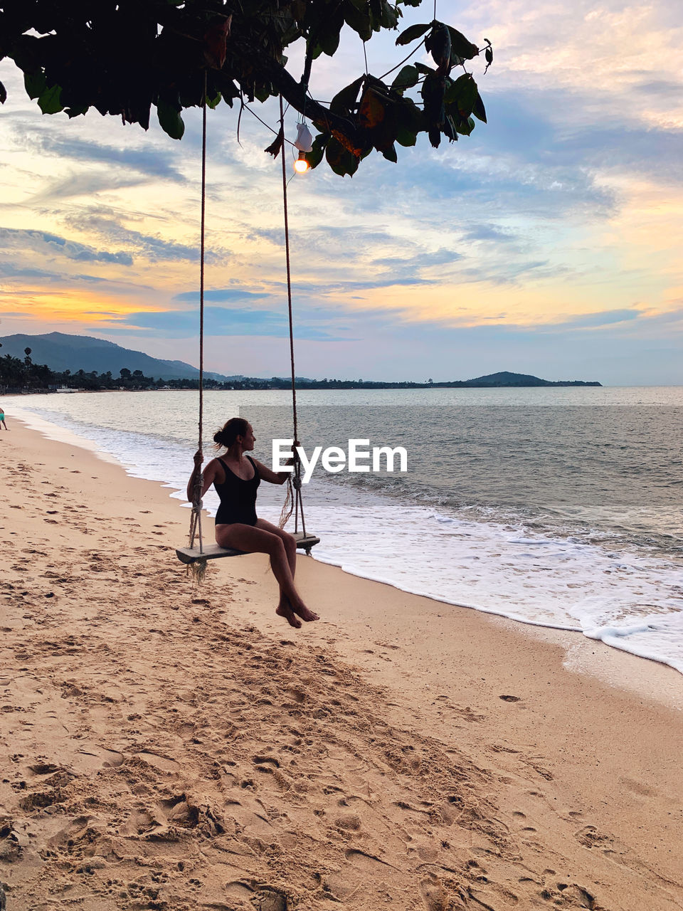 beach, land, water, sea, sky, sand, nature, shore, body of water, full length, one person, cloud, beauty in nature, leisure activity, ocean, coast, vacation, holiday, trip, scenics - nature, lifestyles, sunset, childhood, child, adult, swing, men, relaxation, tranquility, sitting, person, motion, outdoors, women, tranquil scene, tree, female, tropical climate, horizon over water, idyllic, sunlight, wave, sports, travel, summer, travel destinations, enjoyment, horizon, day