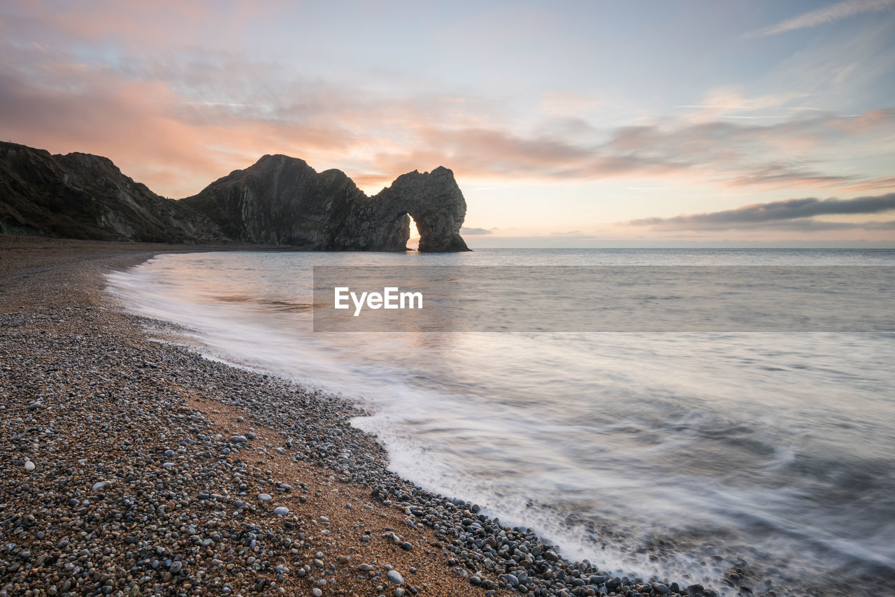 Scenic view of beach against sky during sunset