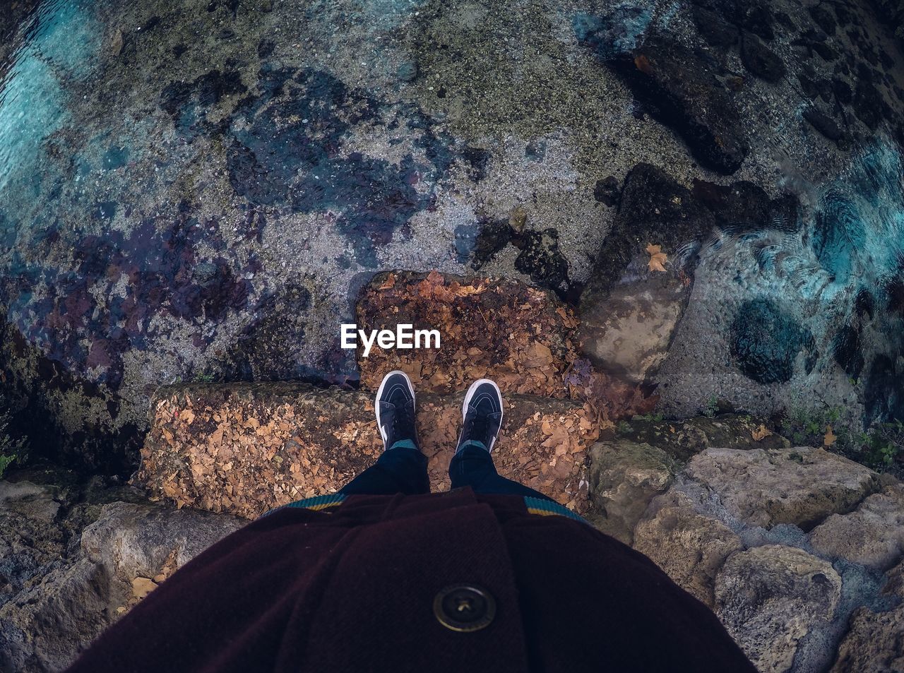 Low section of person standing on rock