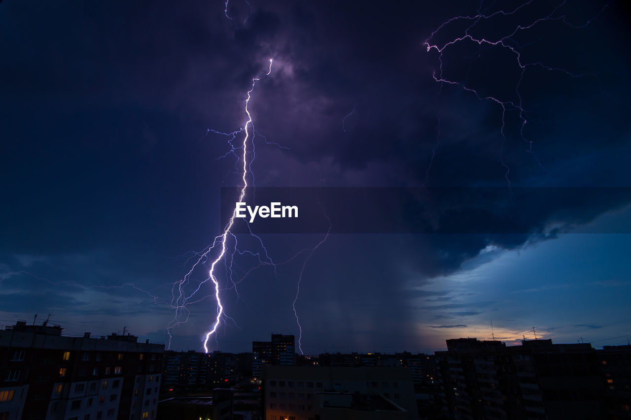Lightning over buildings in city at night