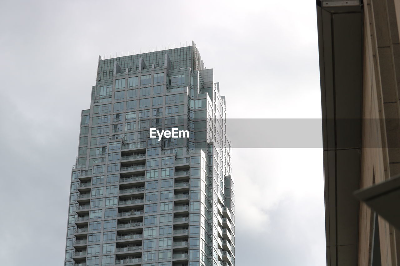 LOW ANGLE VIEW OF OFFICE BUILDINGS AGAINST SKY