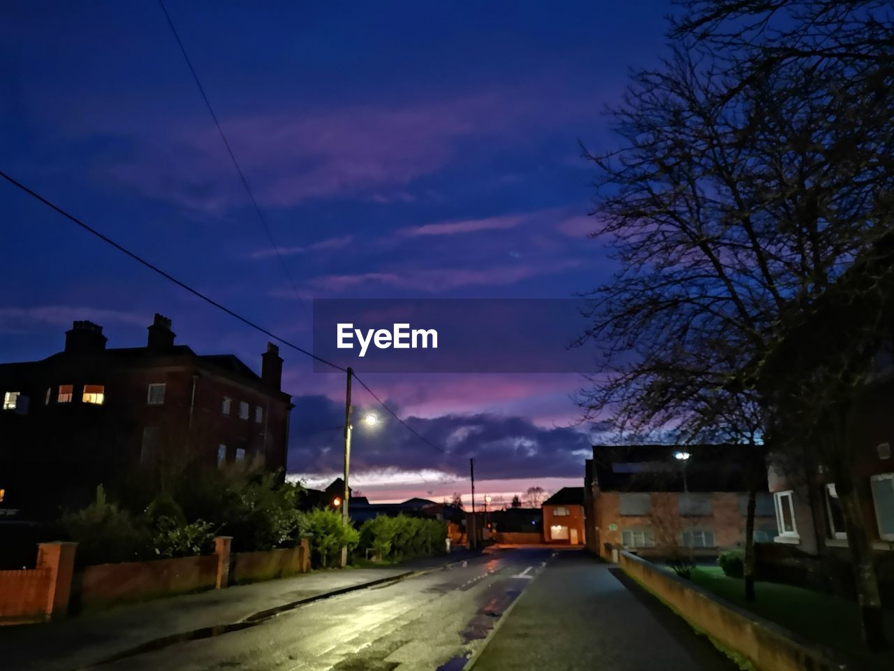 STREET AMIDST BUILDINGS AGAINST SKY