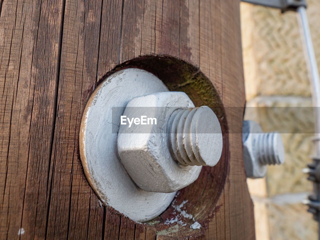 Screw and nut in wooden construction. the detail of the joint on the wooden tower with many screws.