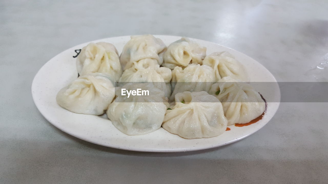 Chinese dumplings in plate on table