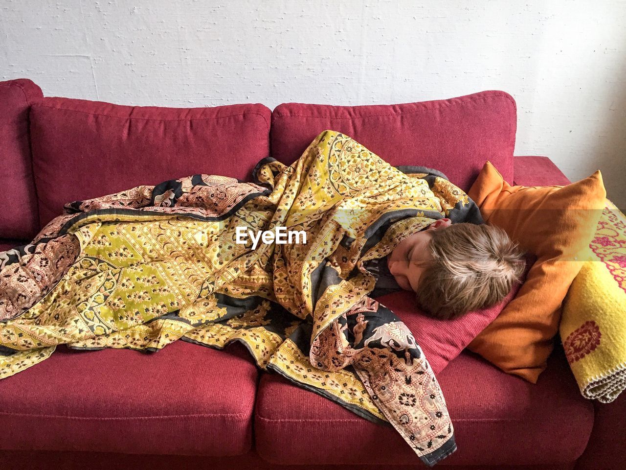 Boy sleeping on sofa at home