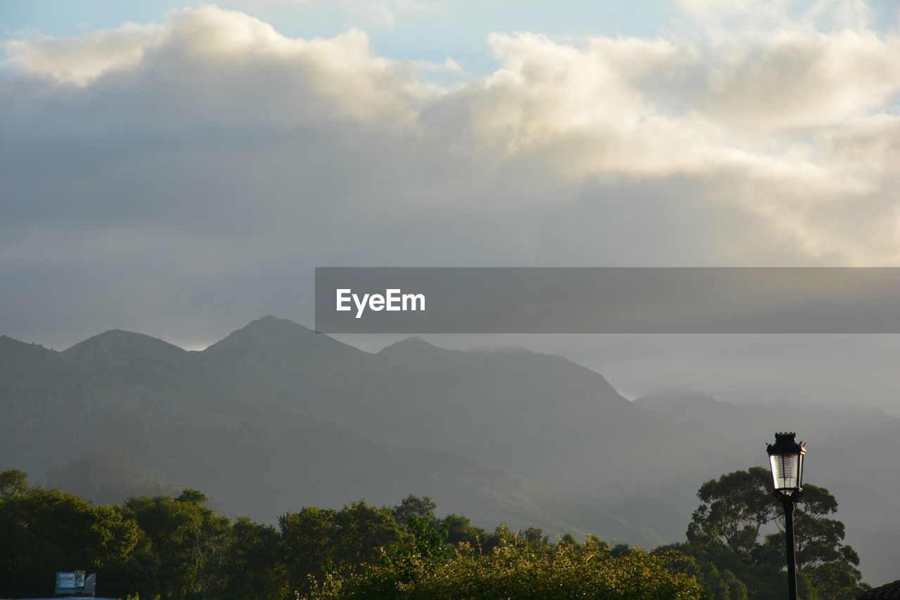 Scenic view of mountains against cloudy sky