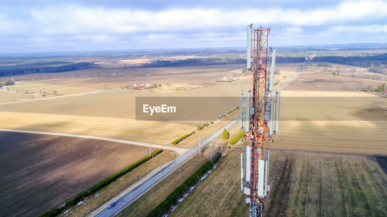 High angle view of communications tower against cloudy sky