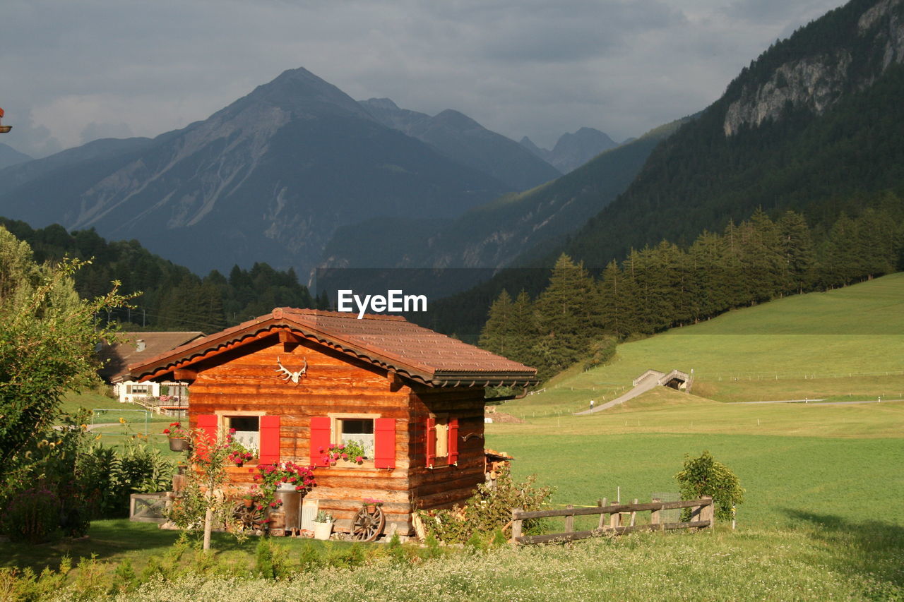 Houses and mountains against sky