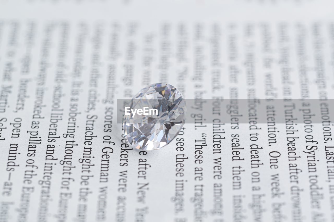 CLOSE-UP OF WEDDING RINGS ON GLASS