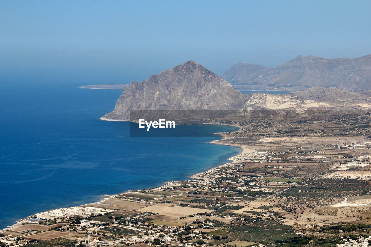 High angle view of bay against clear blue sky