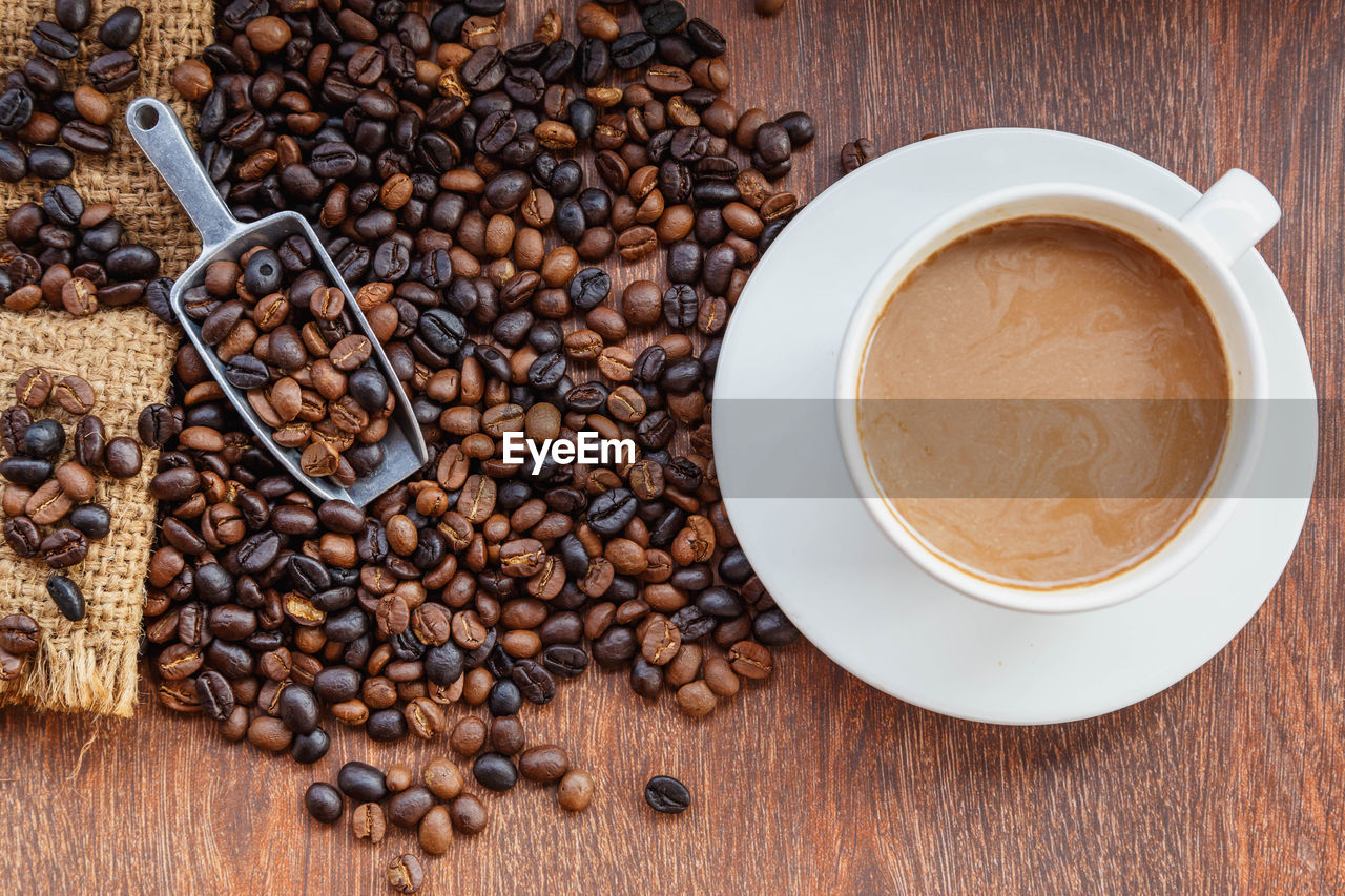 HIGH ANGLE VIEW OF COFFEE CUP AND SPOON ON TABLE