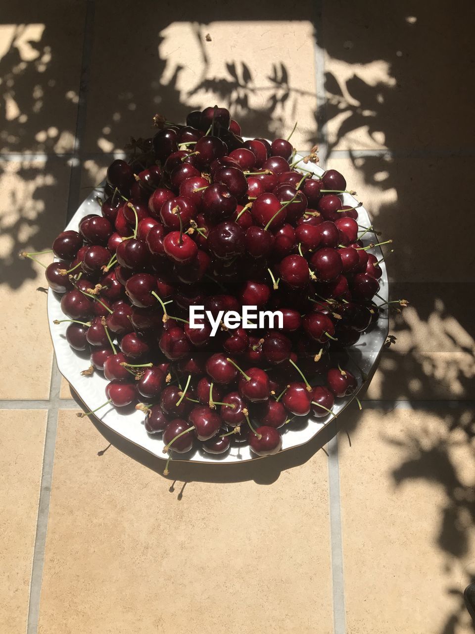 HIGH ANGLE VIEW OF CHERRIES IN PLATE