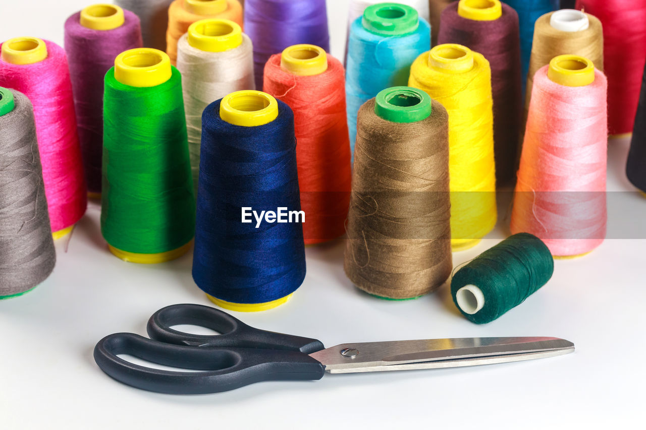 full frame shot of multi colored spools on table