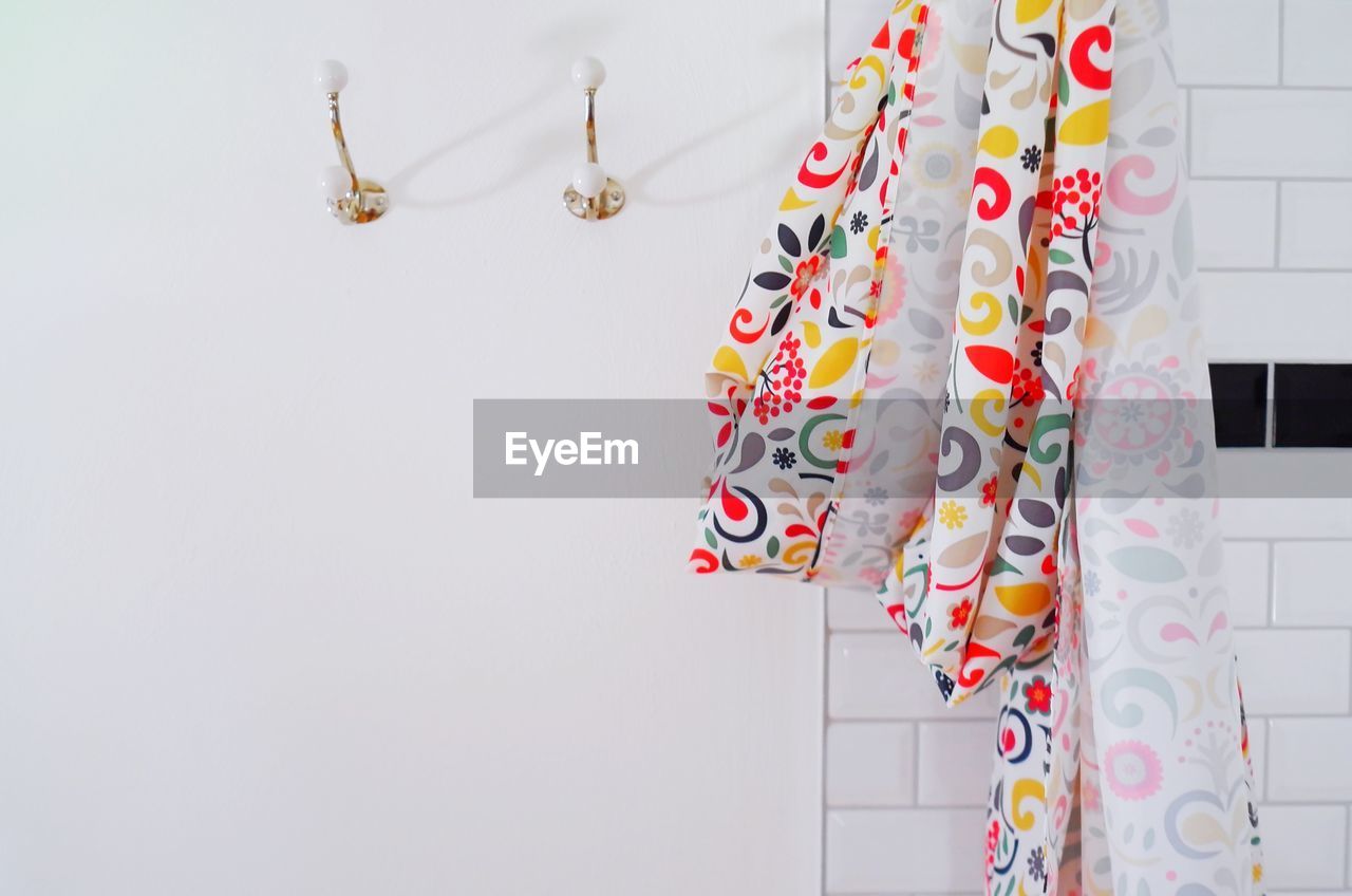 Close-up of multi colored curtain hanging against wall