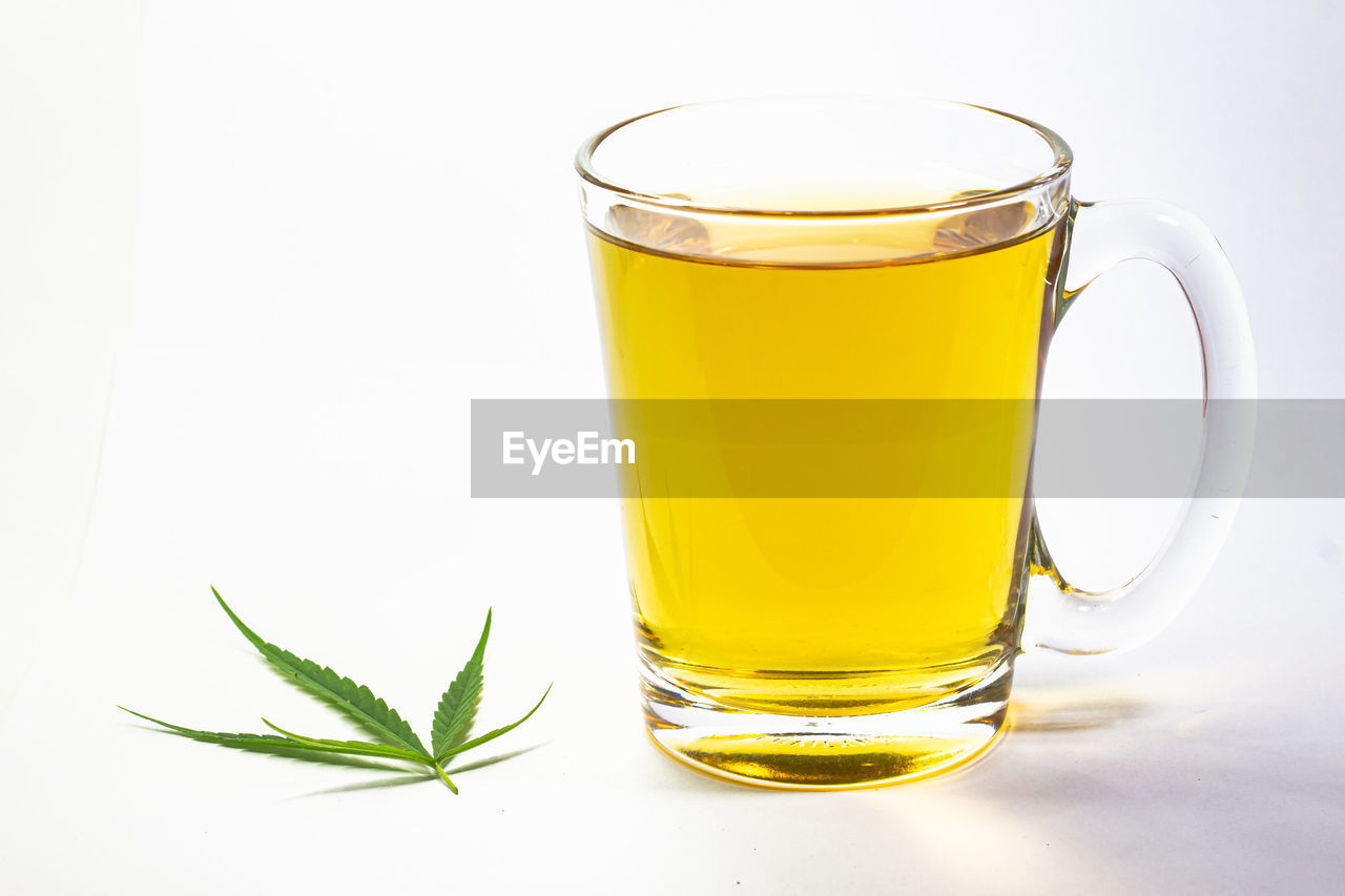 CLOSE-UP OF BEER GLASS ON TABLE