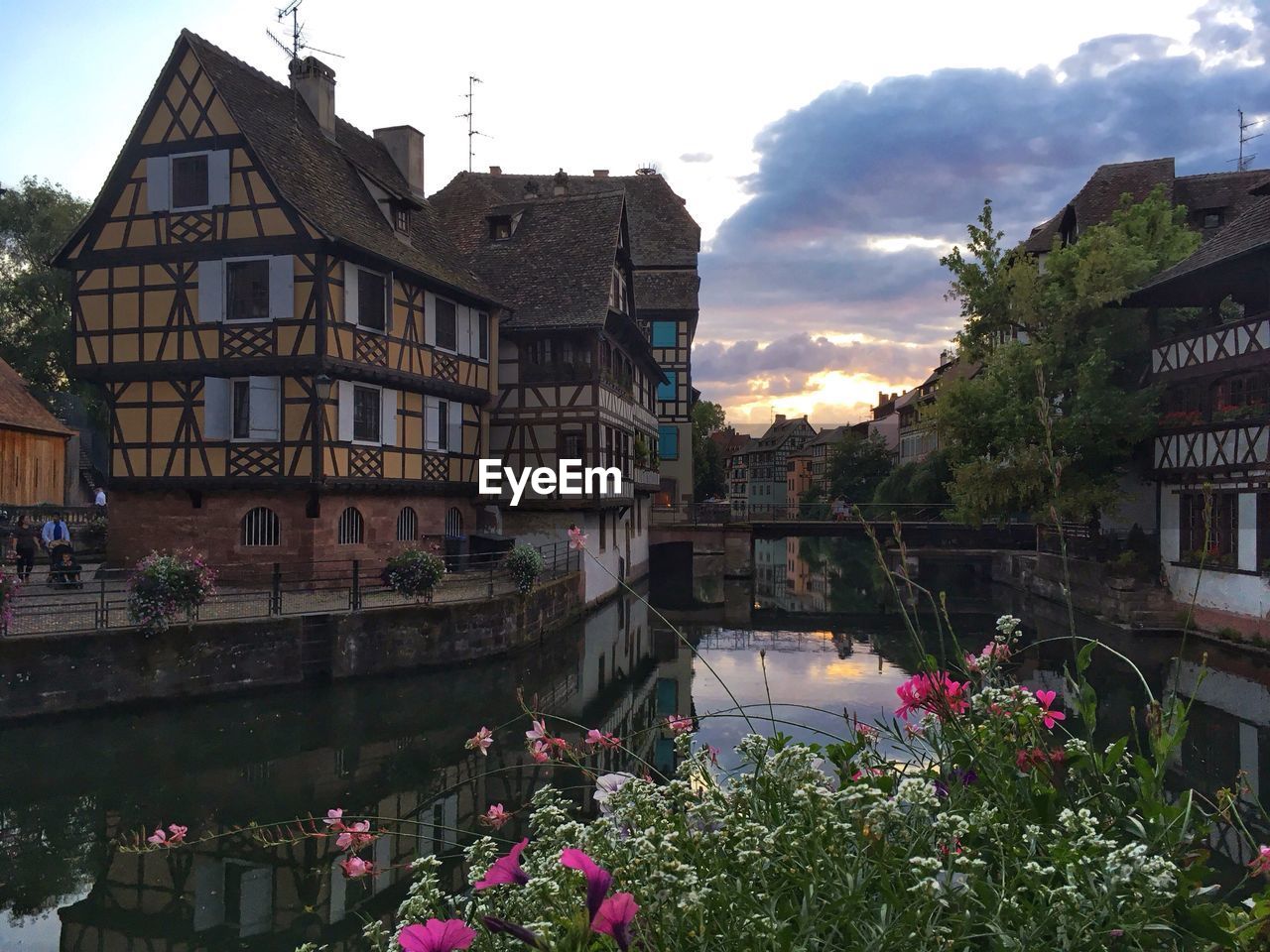 Canal amidst buildings against sky