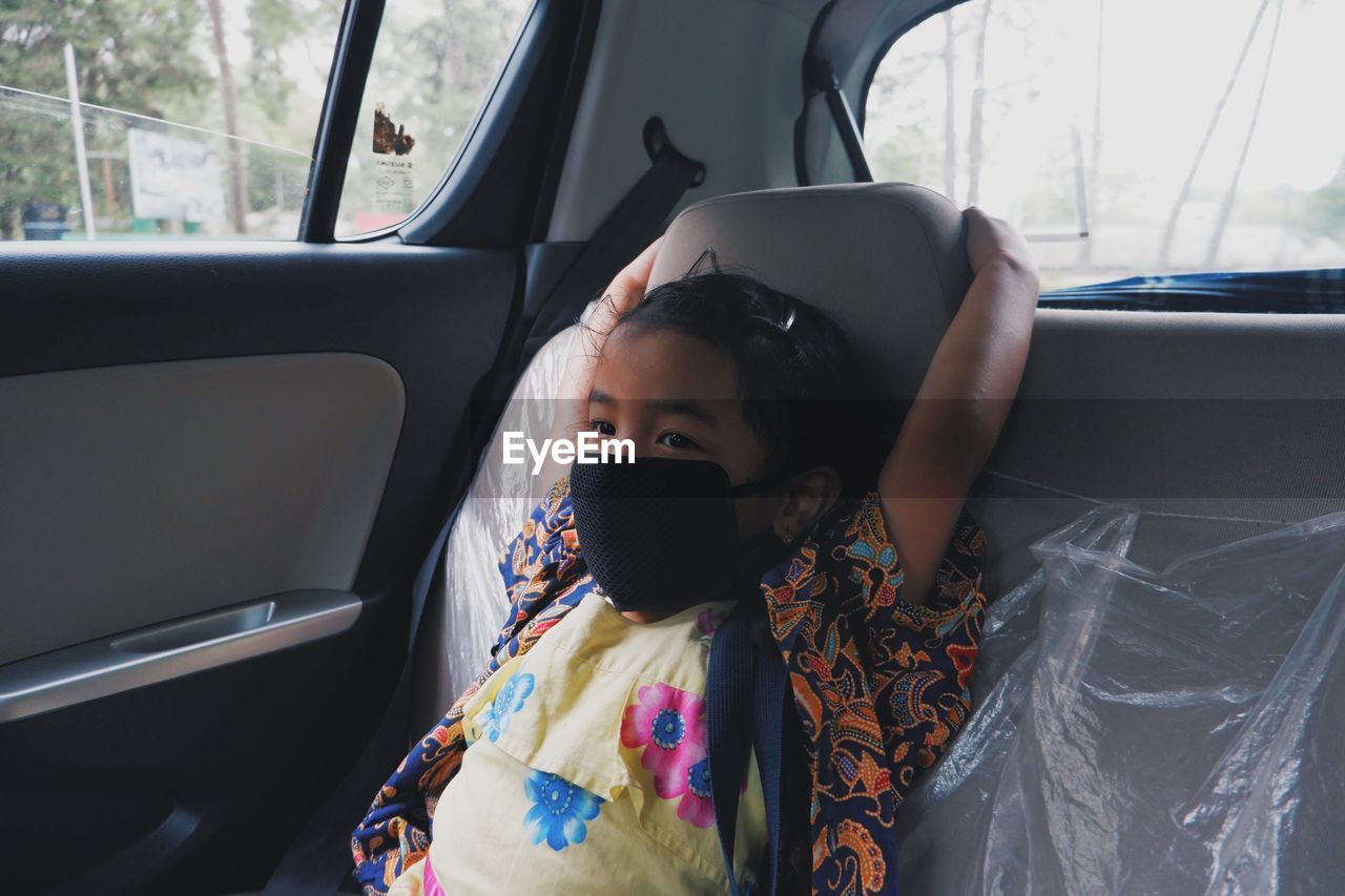 Portrait of young girl in car
