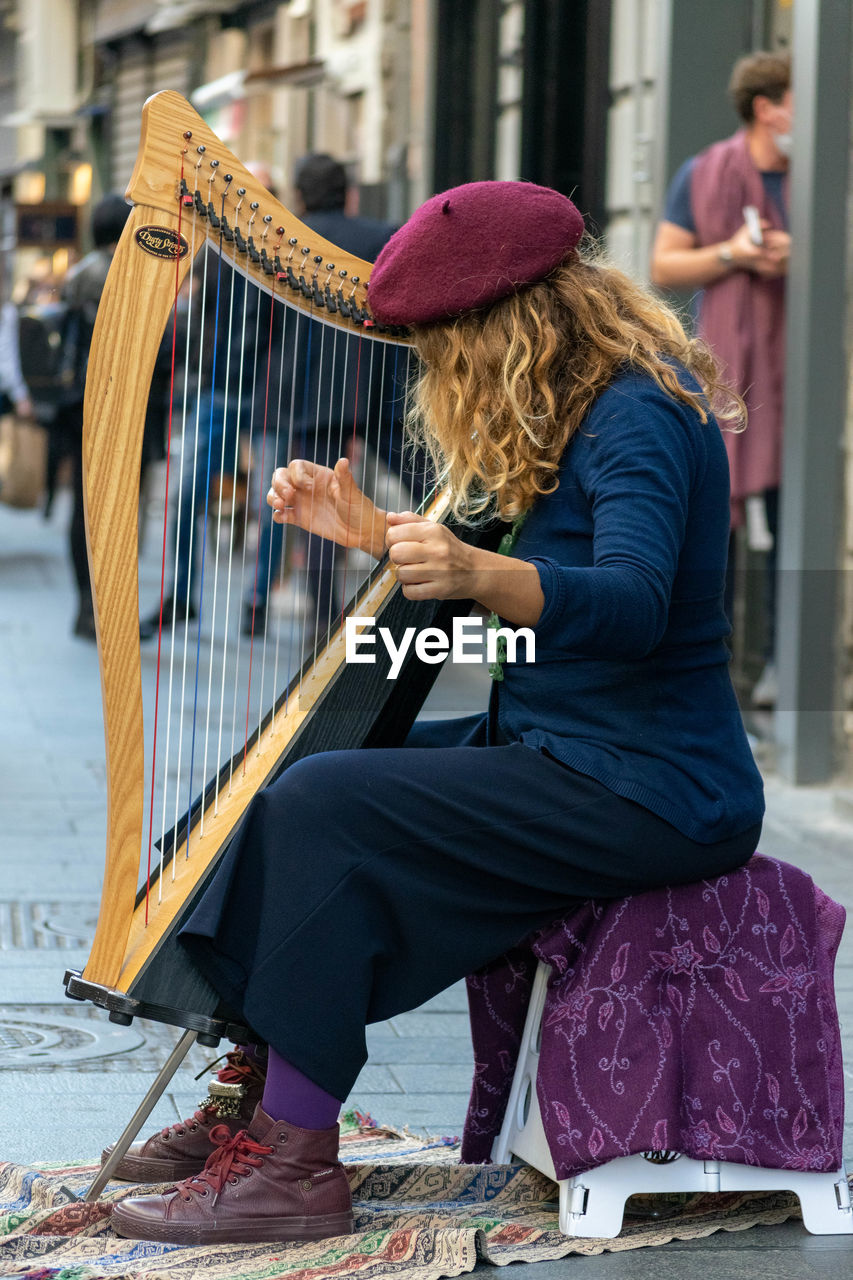 MIDSECTION OF WOMAN PLAYING WITH UMBRELLA