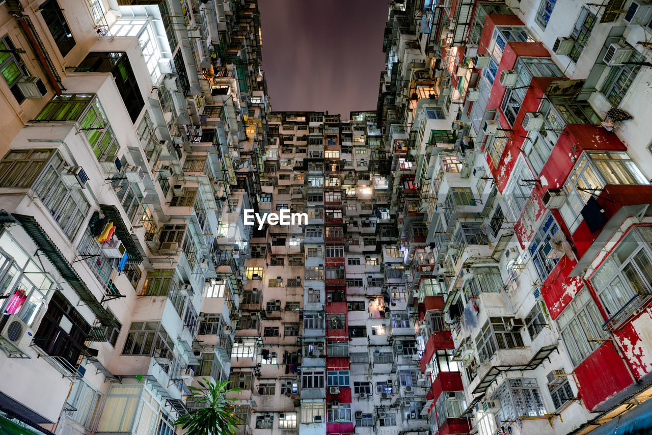 Low angle view of buildings in city at night