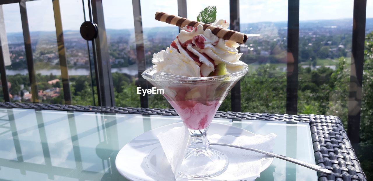 Close-up of ice cream on glass table