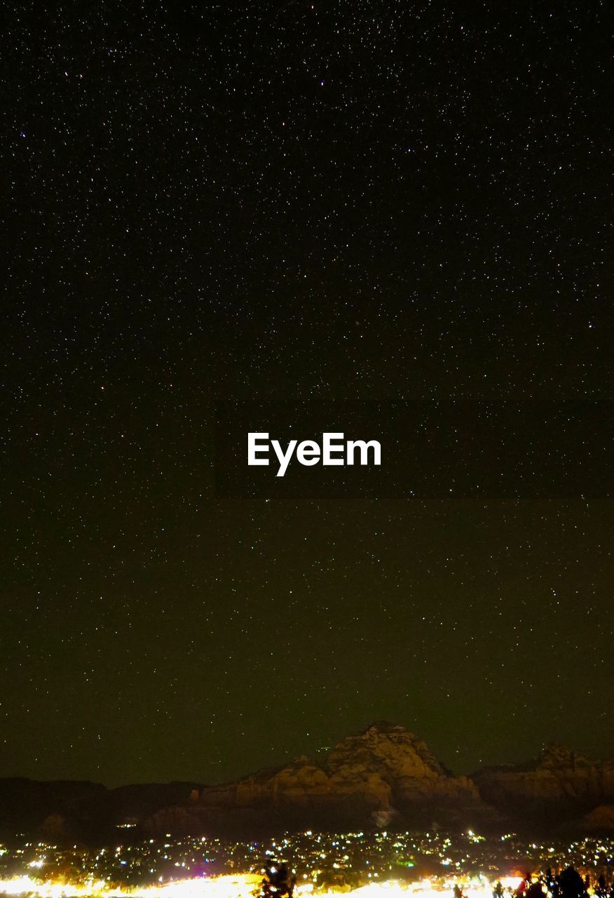 SCENIC VIEW OF ILLUMINATED STAR FIELD AGAINST SKY