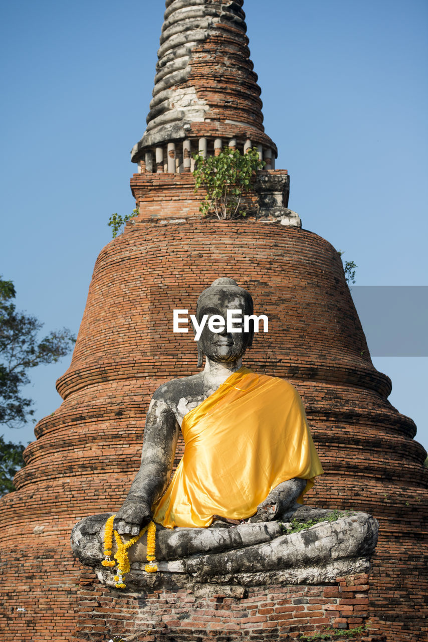 Low angle view of buddha statue and temple