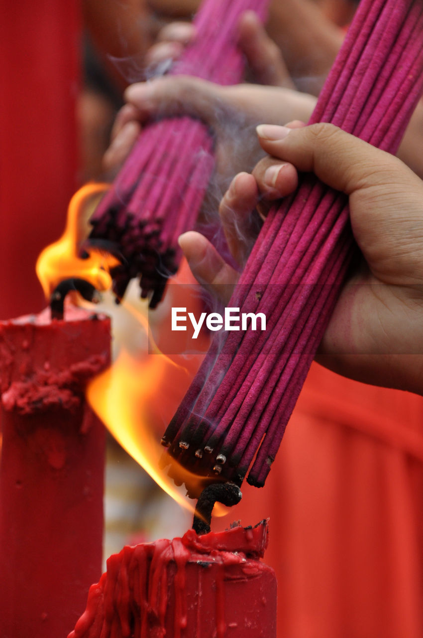 People burning incense sticks