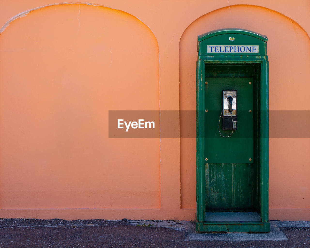 CLOSED DOOR OF BUILDING WITH ORANGE WALL