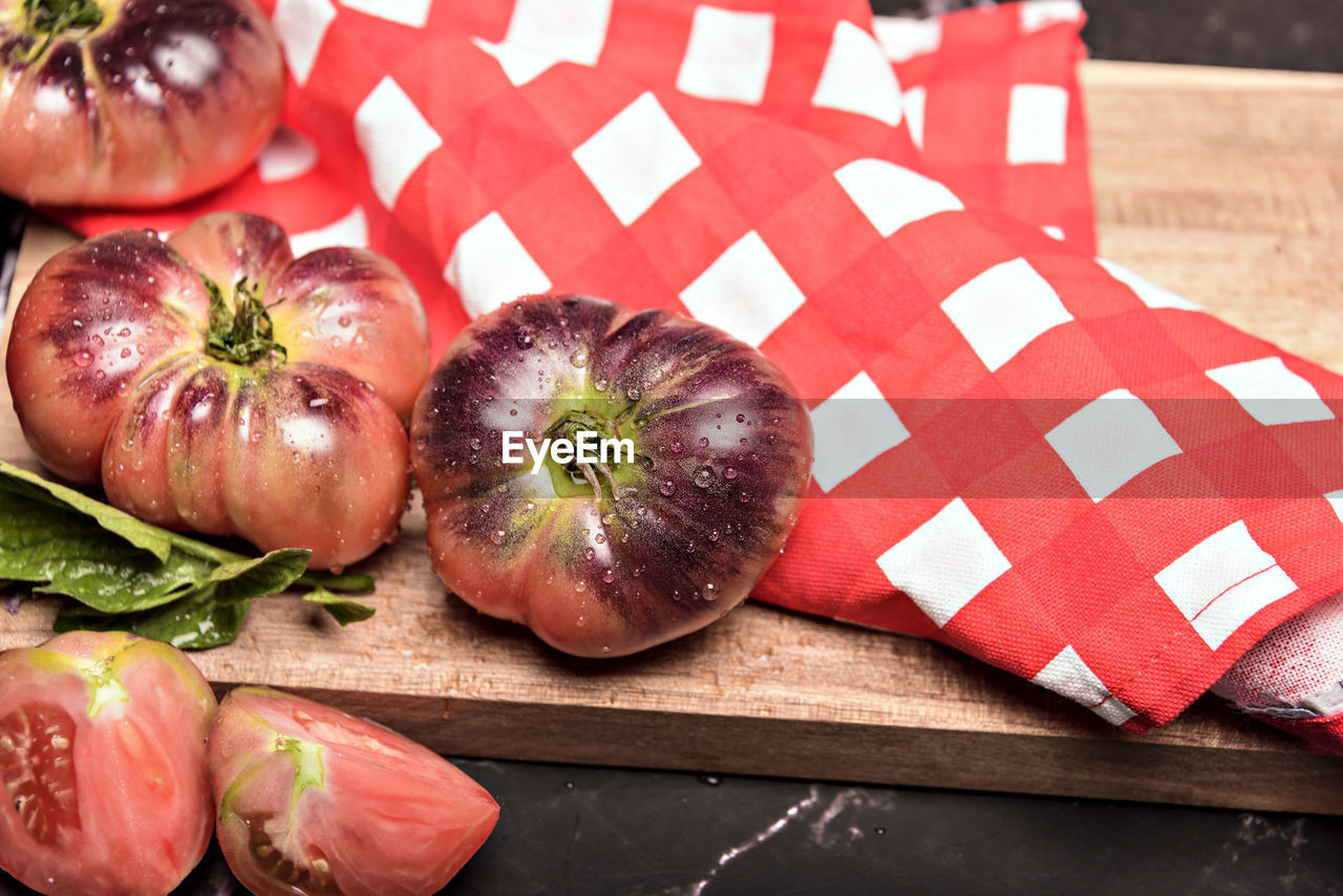 food and drink, food, freshness, healthy eating, vegetable, plant, produce, wellbeing, red, wood, indoors, no people, fruit, cutting board, still life, table, high angle view, studio shot, onion, tomato, dish towel, close-up, kitchen knife, ingredient, organic, checked pattern