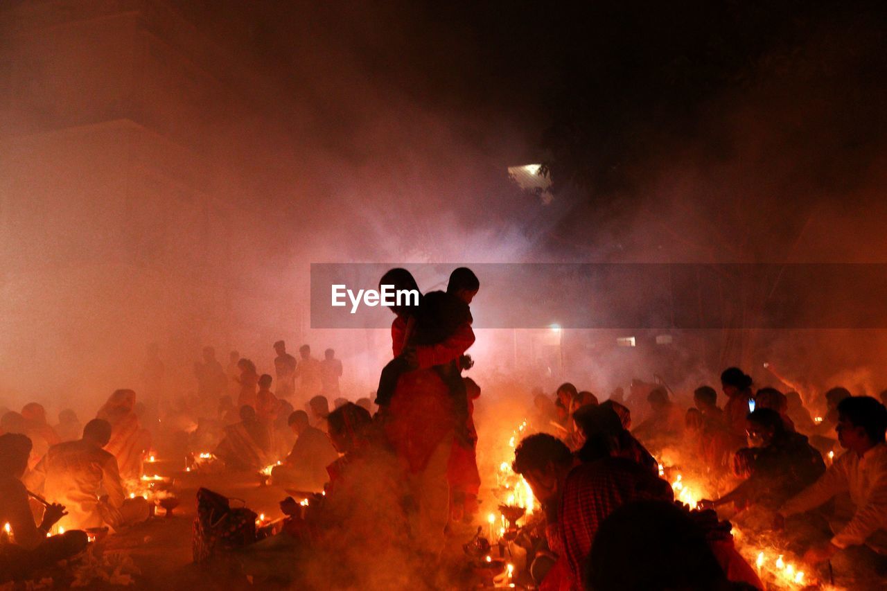 People are praying at rakher upobash in a smokey environment