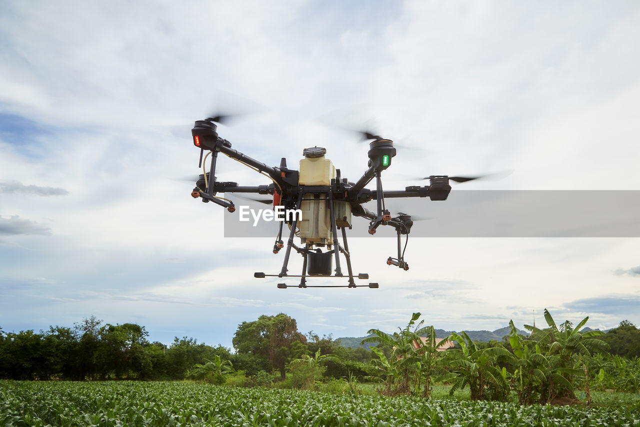 Farmers spray insecticides with agricultural drones