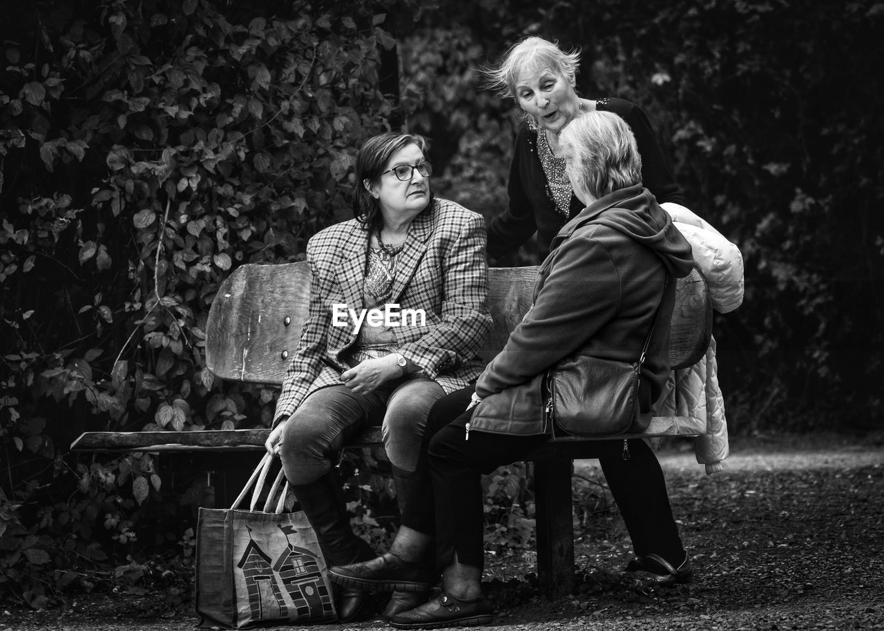 COUPLE SITTING ON BENCH