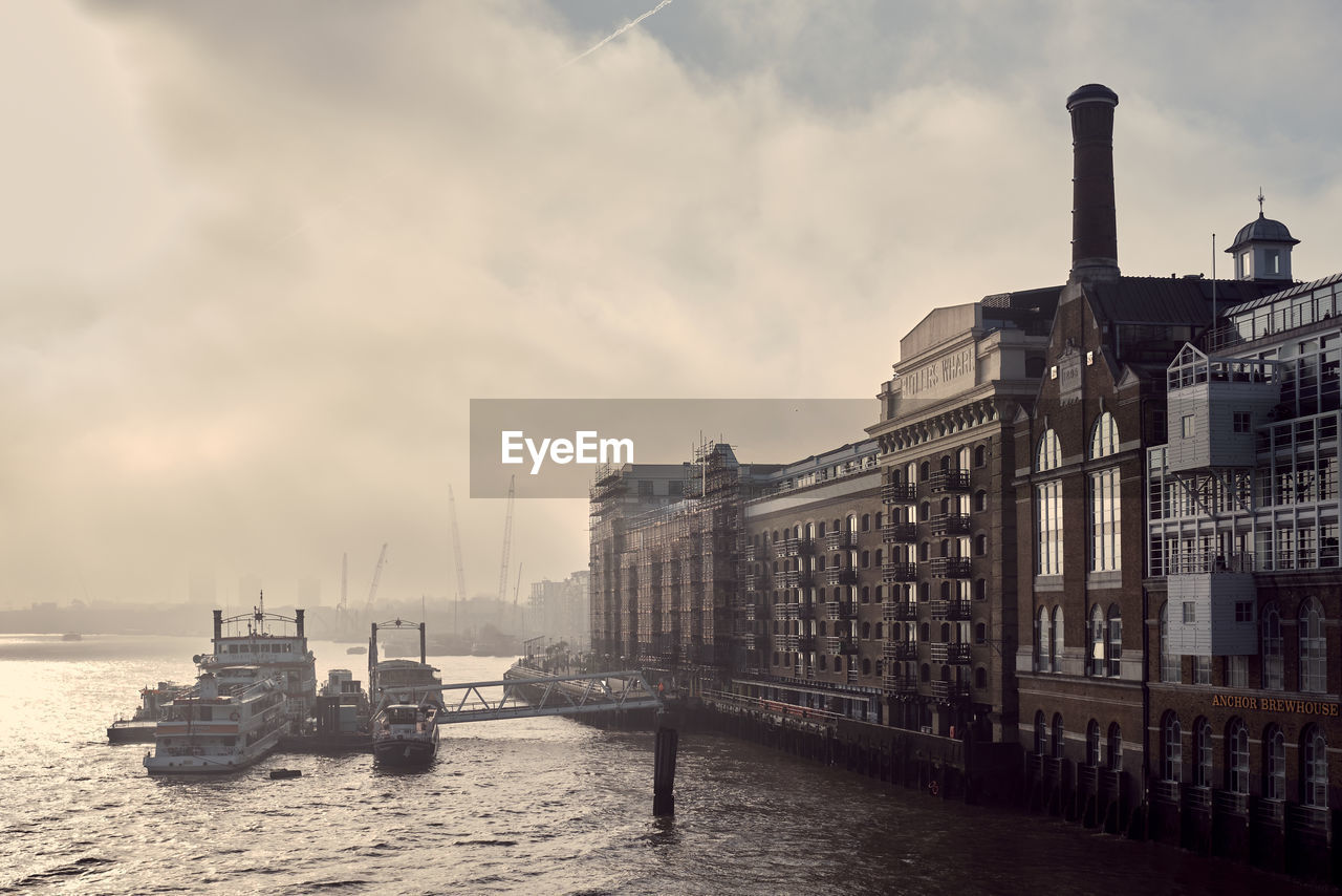 SCENIC VIEW OF SEA AGAINST BUILDINGS IN CITY