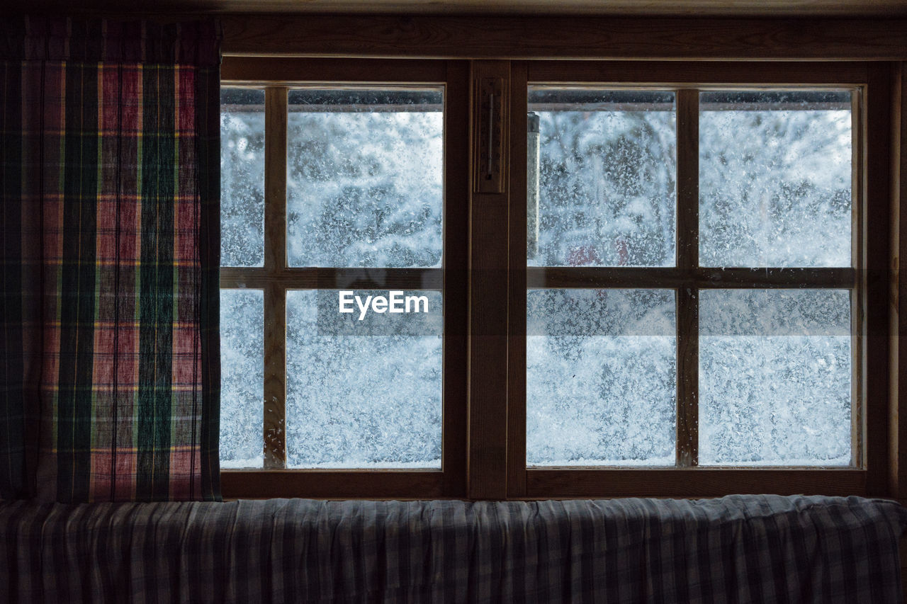 View of frozen window in winter