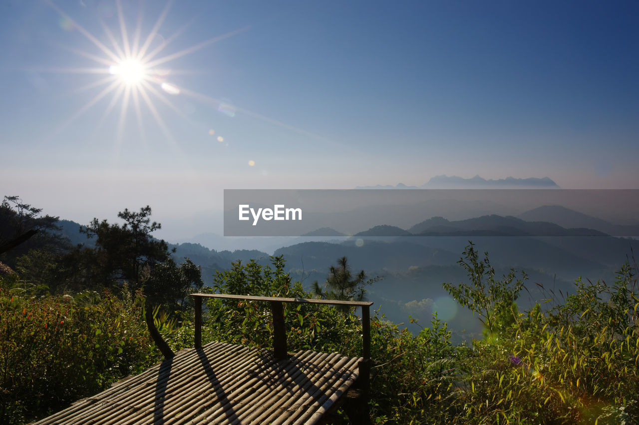 sky, mountain, nature, morning, sunlight, sun, beauty in nature, scenics - nature, environment, plant, landscape, tranquility, mountain range, tranquil scene, horizon, tree, sunbeam, no people, land, outdoors, lens flare, non-urban scene, idyllic, sunrise, architecture, railing, travel, blue, cloud, day, sunny, travel destinations, summer