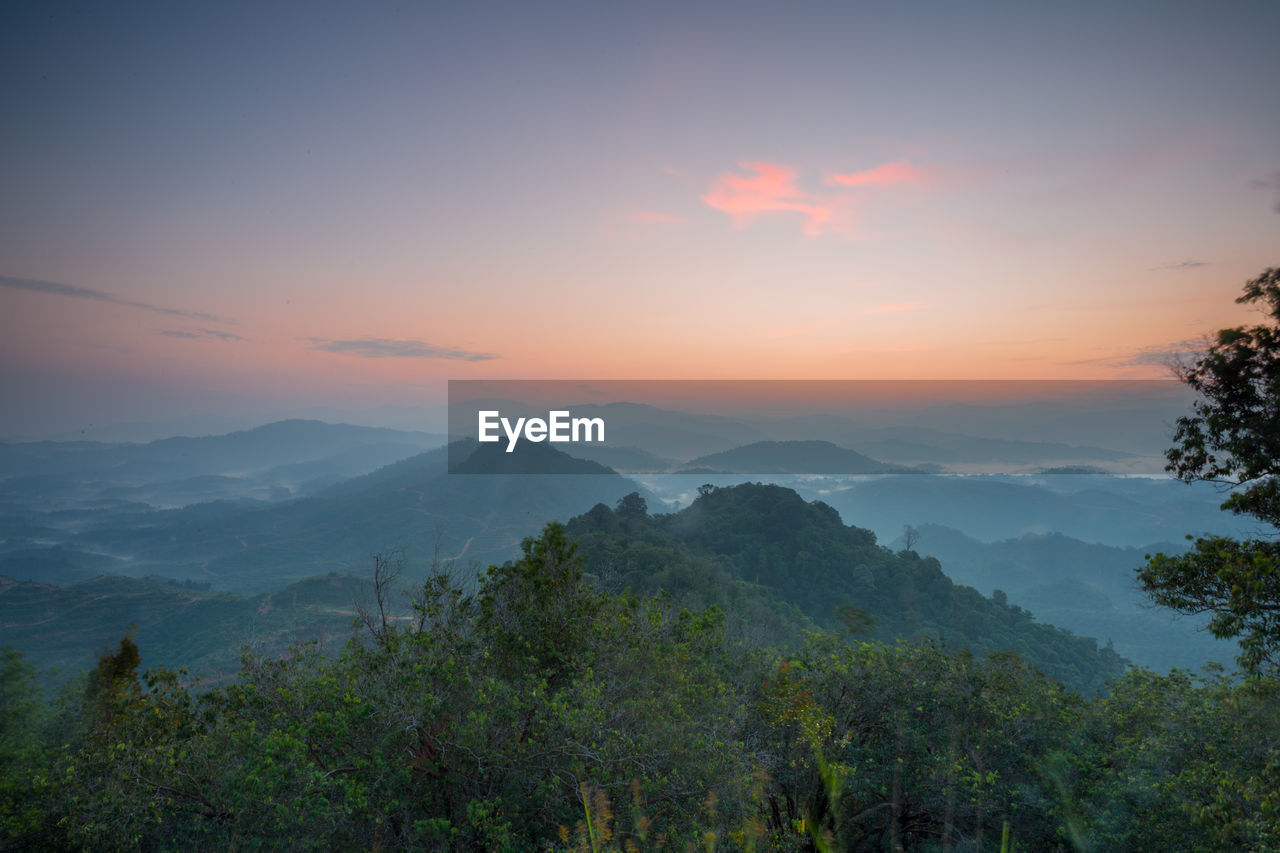 Scenic view of mountain against sky at sunset