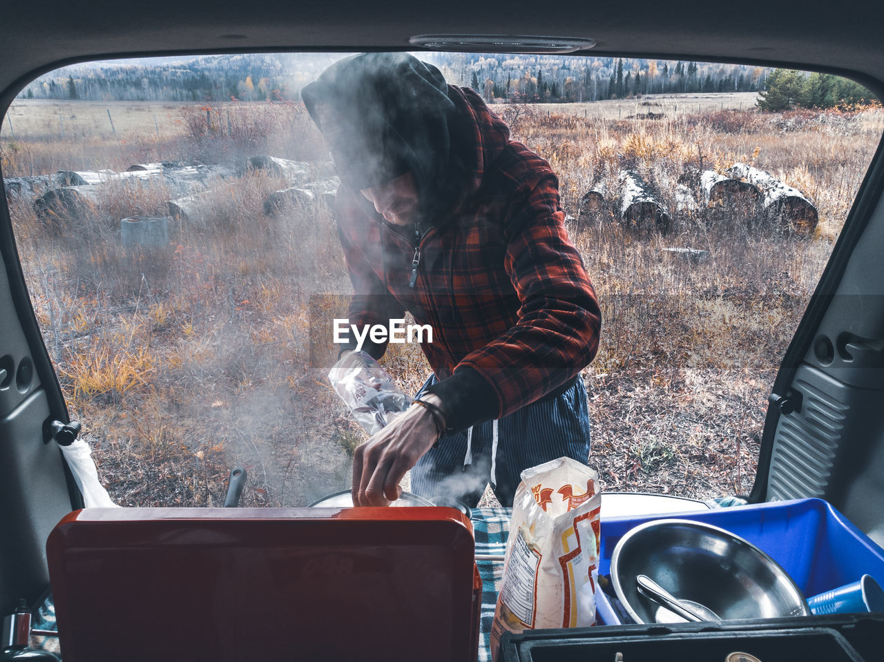 Man cooking in a car, camping, camper