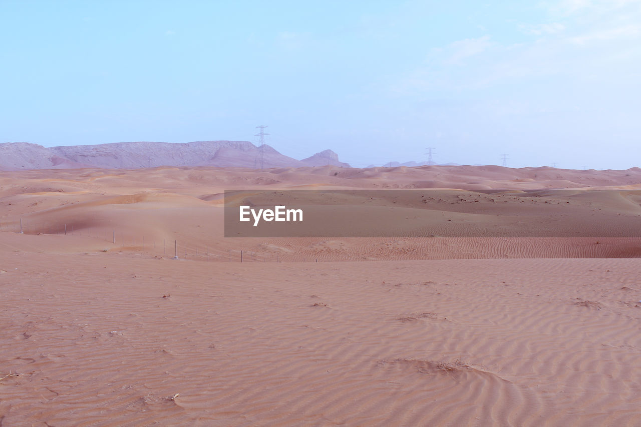 SAND DUNE IN DESERT AGAINST CLEAR SKY