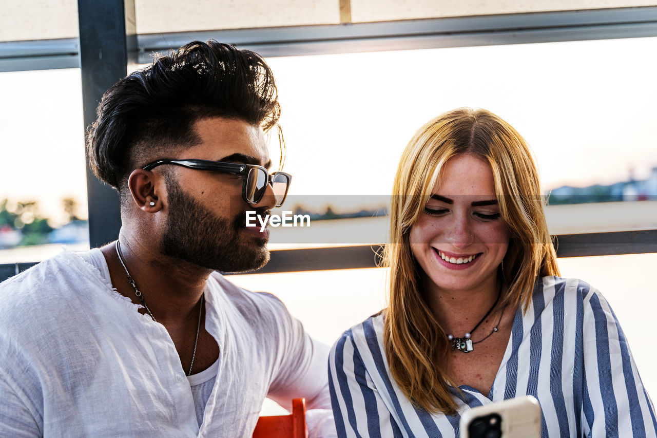 Portrait of an engaged multiethnic couple having fun on summer vacation on a river cruise ship