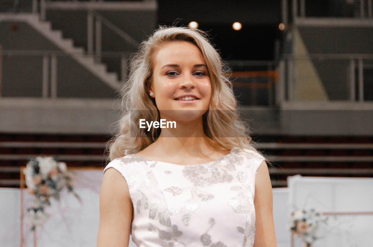 Portrait of smiling woman standing outdoors