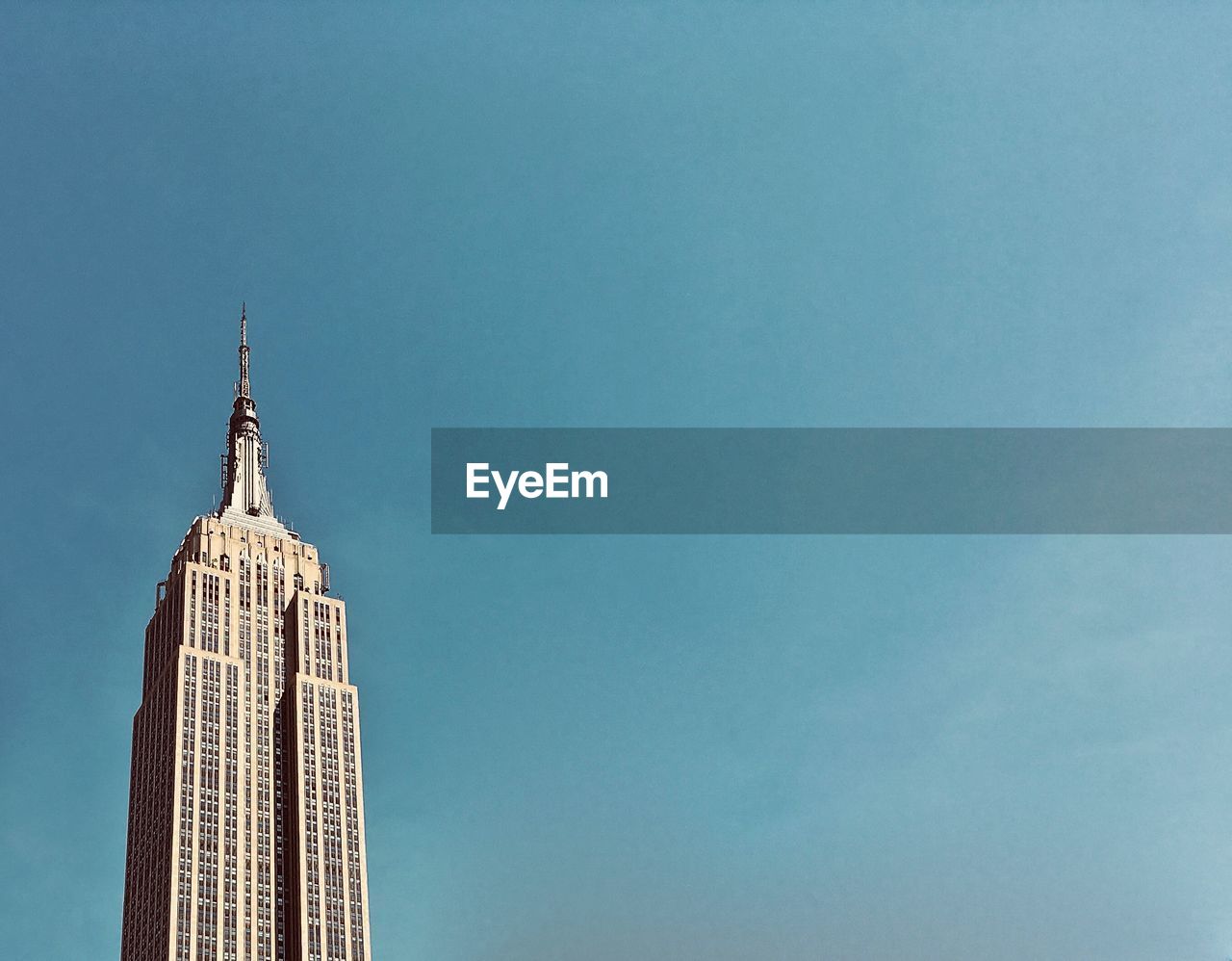 Low angle view of empire state building against clear sky