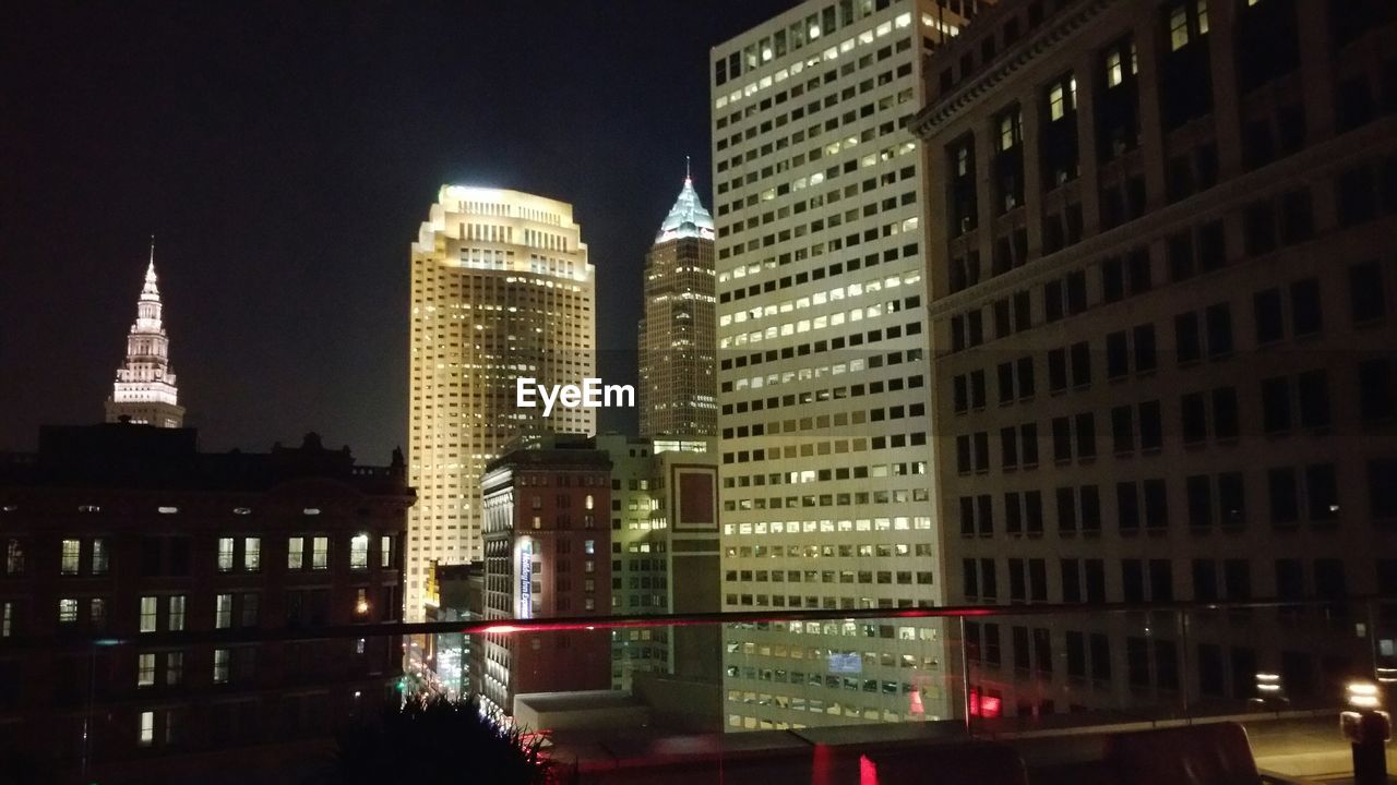 ILLUMINATED MODERN BUILDINGS AT NIGHT