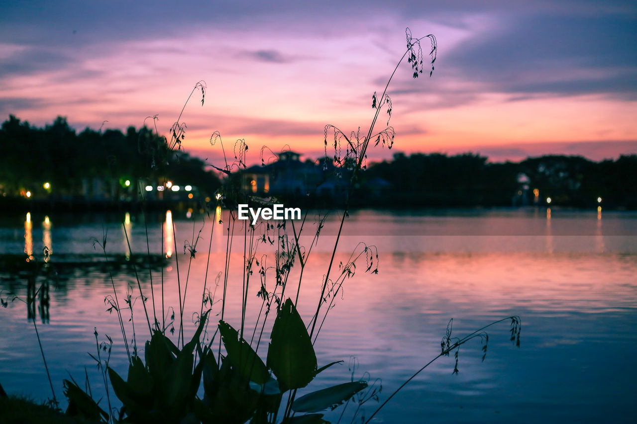 Scenic view of lake against sky at sunset