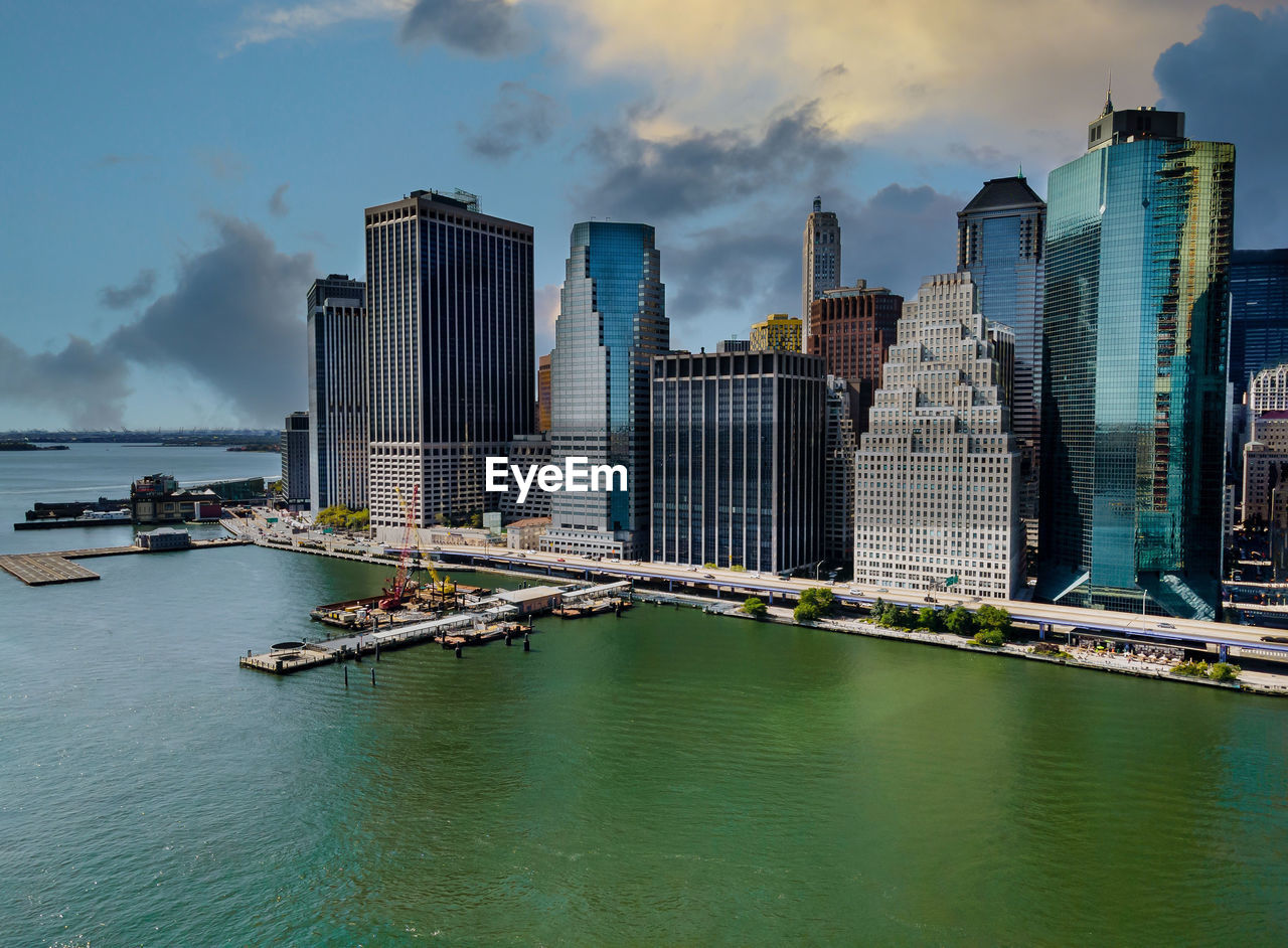 PANORAMIC VIEW OF SEA AND MODERN BUILDINGS AGAINST SKY