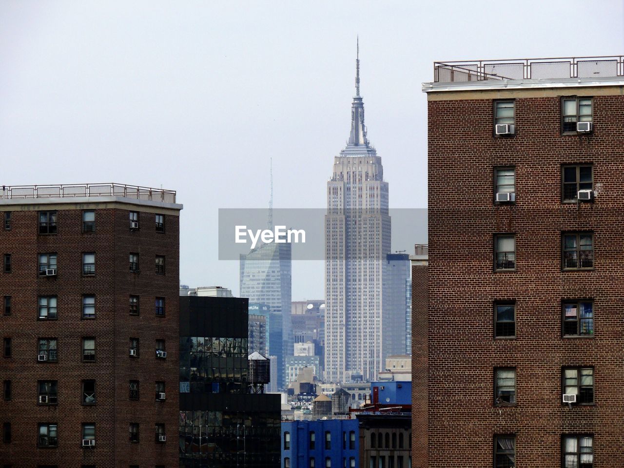 Buildings in city against clear sky