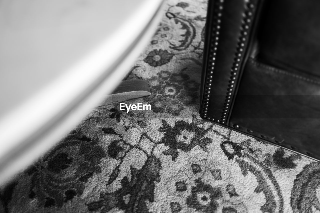 High angle view of table and chair on carpet